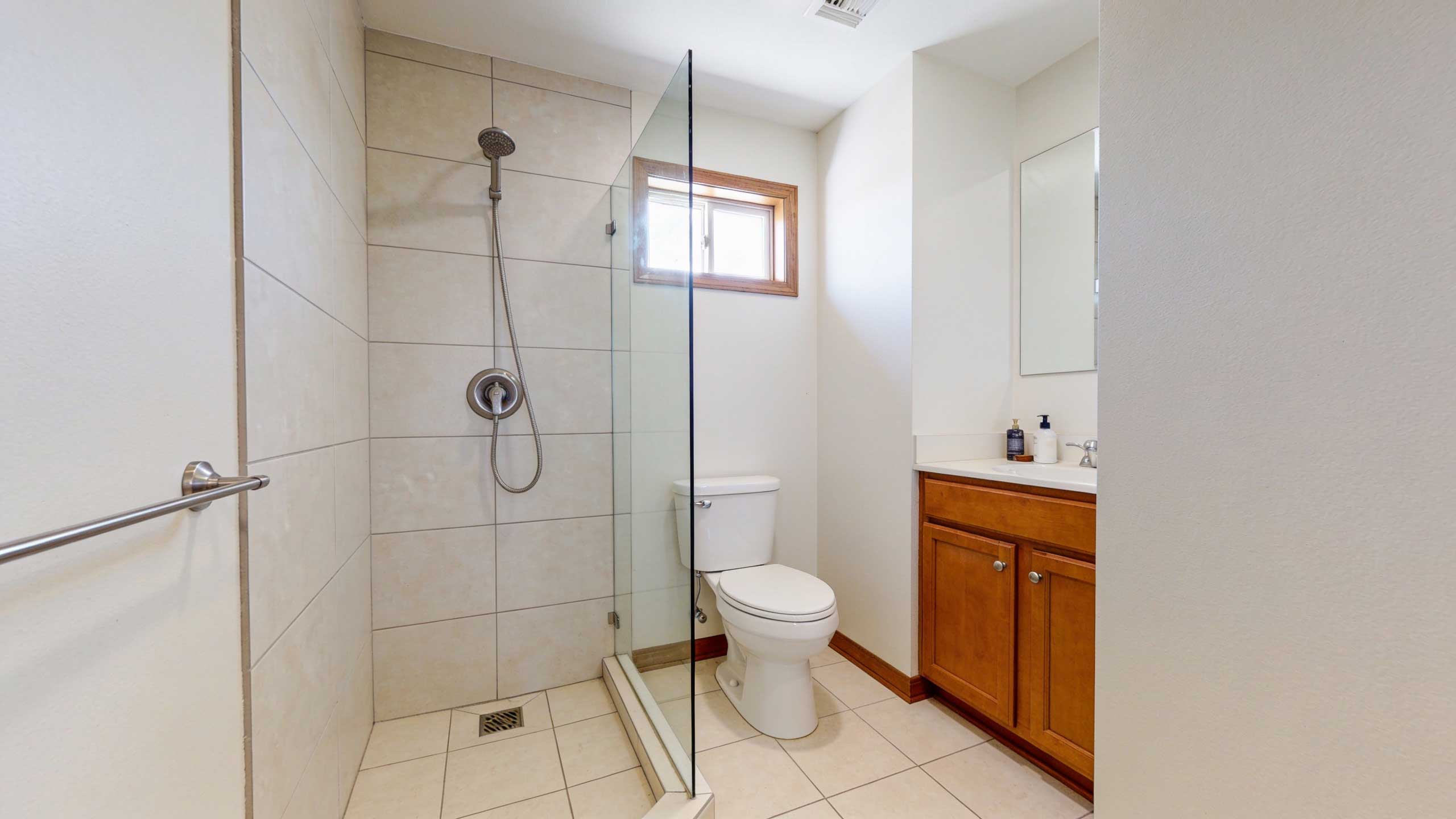 Open corner doorless shower designed to save space in a small bathroom