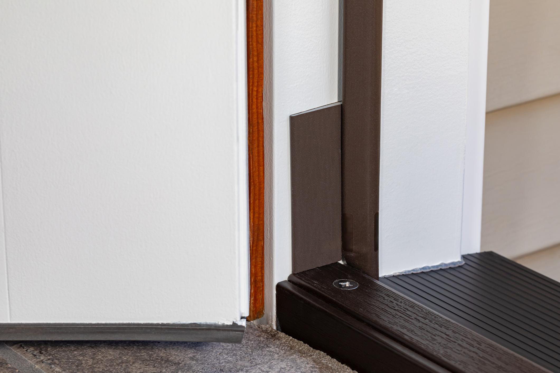 Weatherstripping fitted along the side of a closed exterior door and a sweep positioned along the bottom edge.